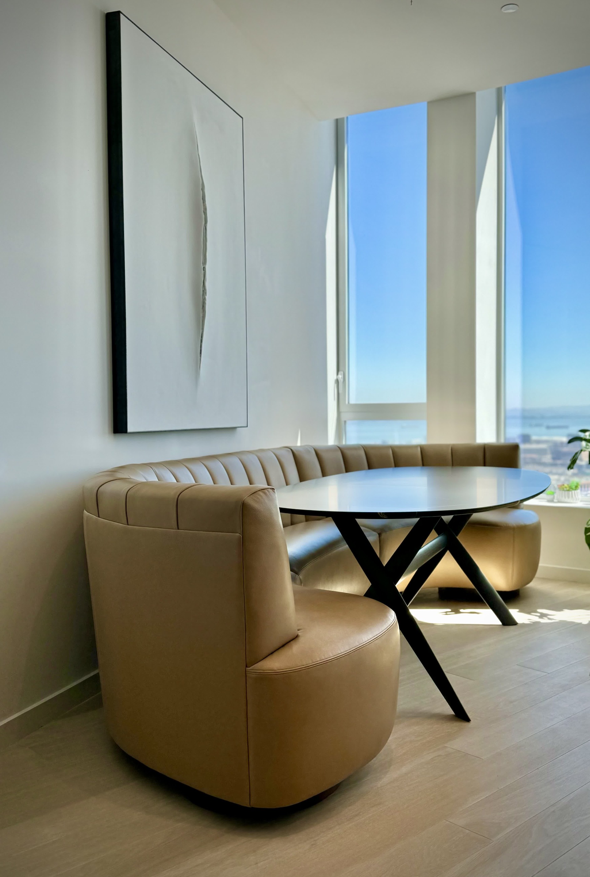 Curved dining banquette beside a window