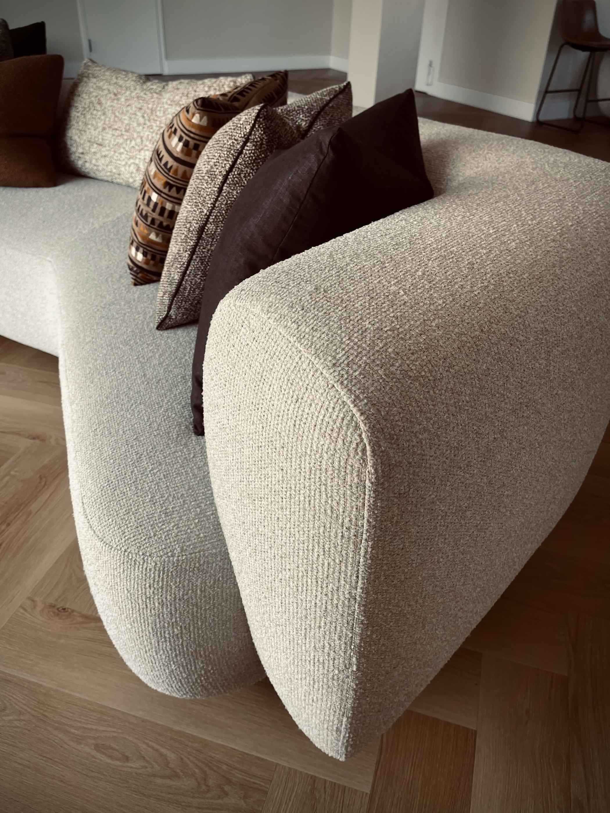 Close detail of a curved upholstered sofa arm