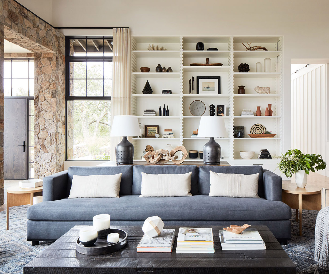 Calistoga tailored blue sofa before white shelves