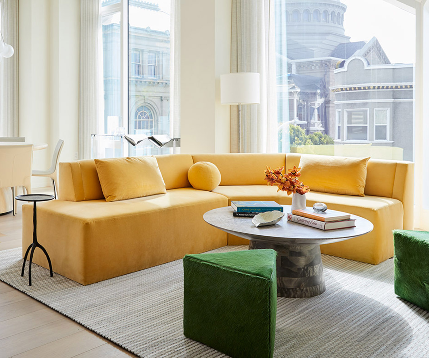 Yellow sectional and green upholstered ottomans in a bright Pacific Heights interior